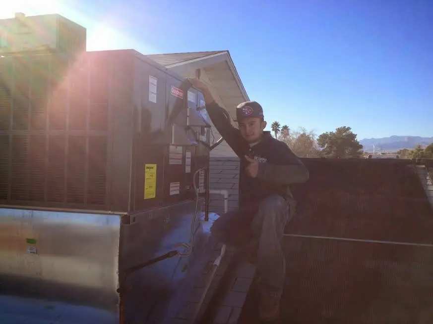 HVAC technician performing HVAC Inspection on a rooftop unit in Beech Grove